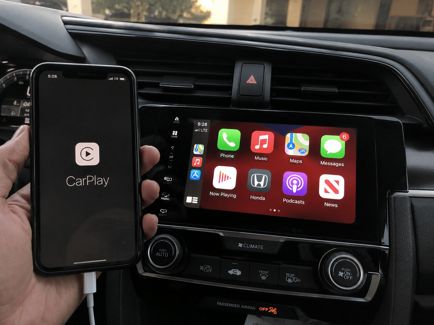 iPhone connected to head unit showing CarPlay screen